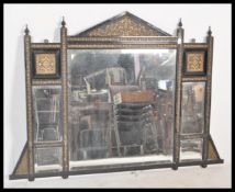 A large 19th Century Victorian ebonised overmantel wall mirror having bevelled glass mirror panels