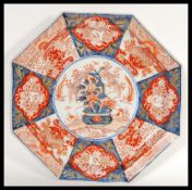 A Japanese Meiji period Imari charger plate of octagonal form having hand painted decoration