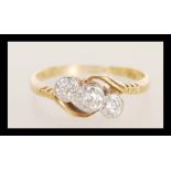 A stamped 18ct gold platinum ring illusion set with three brilliant cut diamonds. Weight 1.8g.