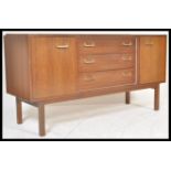 A vintage retro teak mid 20th Century sideboard, cupboard either side and a bank of 3 central