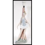 A Lladro ceramic figural table lamp in the form of a ballerina complete with lamp shade. Measures