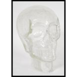 A retro 20th Century clear crackle glass skull head having moulded features with crackle design.