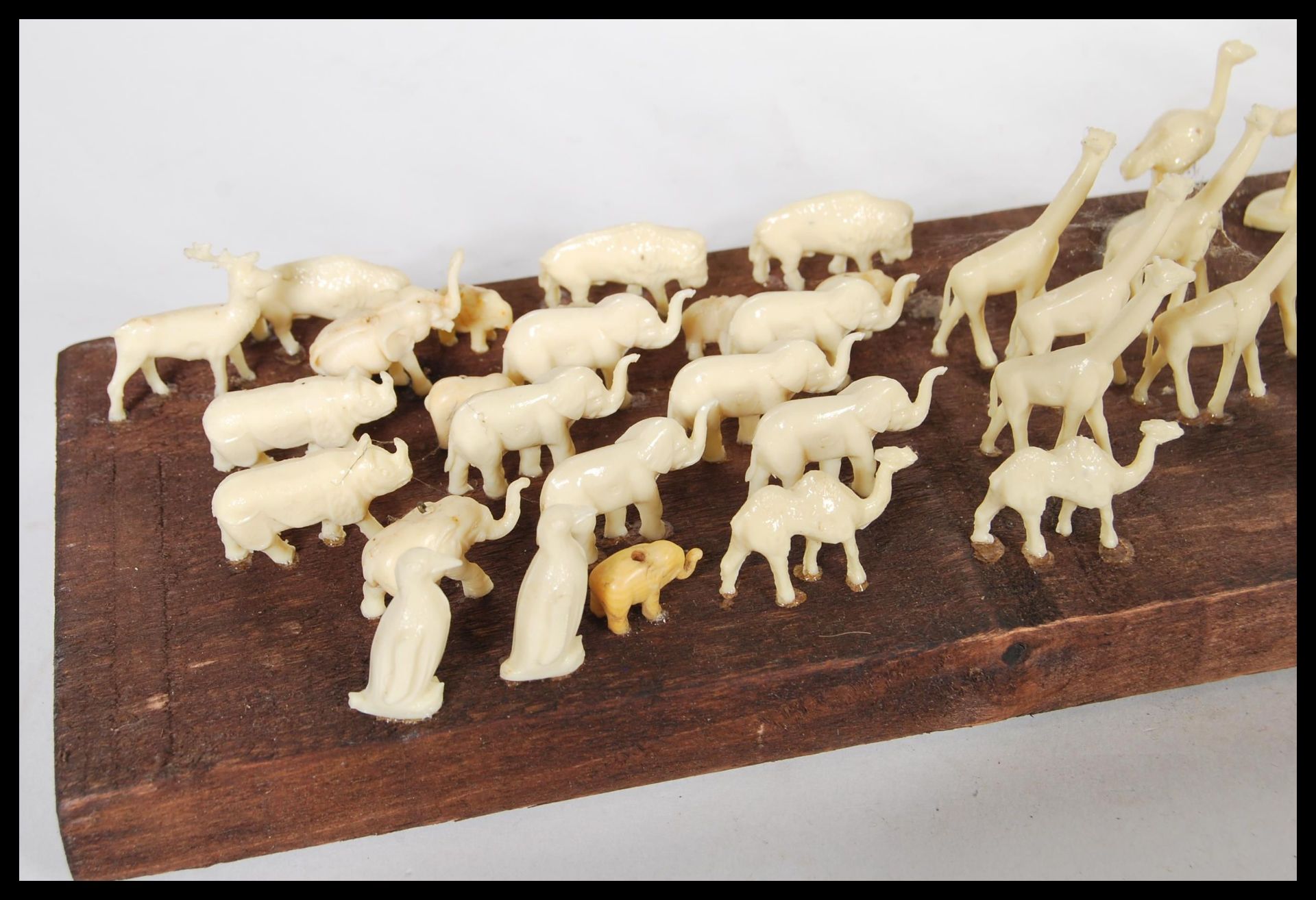 A selection of white faux ivory cast resin figures of animals mounted on a stained wooden base along - Bild 2 aus 5