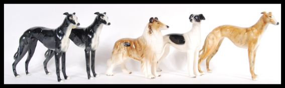 A collection of four china greyhound figurines in the manner of Beswick along with a Rough Collie