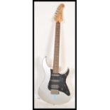 A vintage Yamaha Pacifica PAC112X stratocaster style electric six string guitar. Silver, with