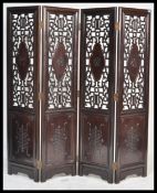 A large 20th Century Chinese padauk wood four panel folding discretionary screen room divider having