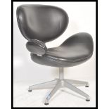 A contemporary Scandinavian 'egg ' design swivel desk chair having a shaped vinyl backrest and