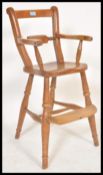 A 19th Century Victorian beech and elm high chair having a bar back with shaped supports and