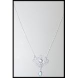 A stamped 925 silver necklace having an art nouveau style pendant set with cz's and opals, set to