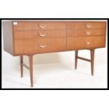 A vintage retro 20th Century teak wood sideboard of Danish influence having six drawers with brass