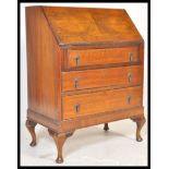 An early 20th Century Edwardian walnut veneer writing office bureau desk having a fall front with