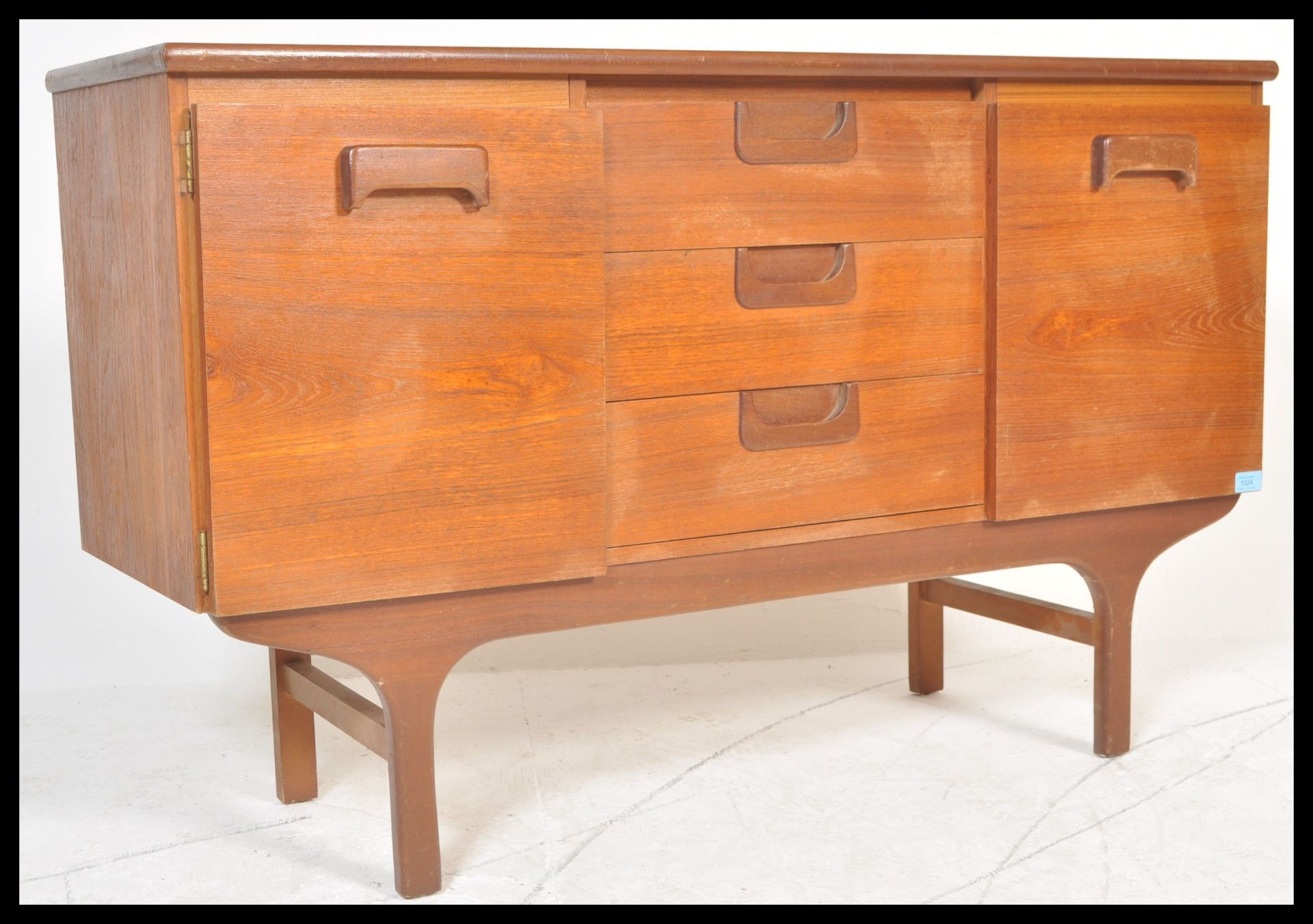 A vintage retro 20th Century teak wood sideboard of small proportions having central bank of three