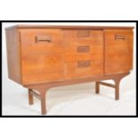 A vintage retro 20th Century teak wood sideboard of small proportions having central bank of three