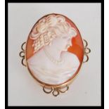 A 9ct gold hallmarked ladies shell cameo brooch. The central cameo depicting maiden inset to an oval