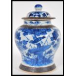 A 19th Century Chinese lidded jar or vase and cover having a crackle glaze ground with blue hand