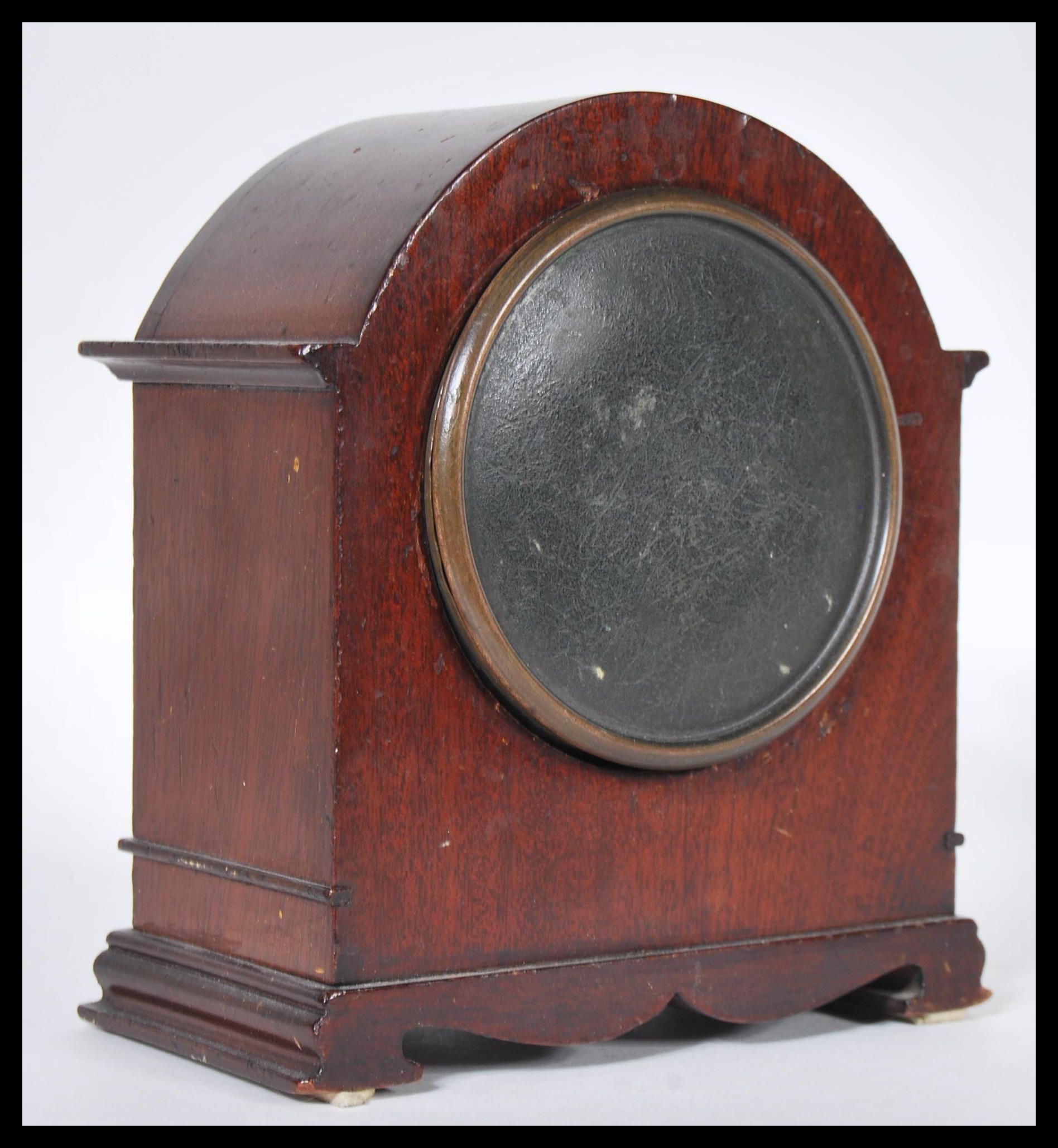 A 20th Century mantel clock having a mahogany case of domed form with a round white enamelled - Image 2 of 3