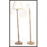 Two vintage mid 20th Century floor standing standard lamps, raised on circular footed base, turned