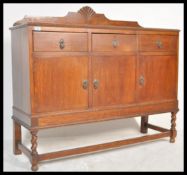 An early 20th Century oak sideboard / credenza having a configuration of three drawers over