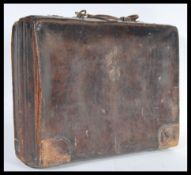 A vintage 20th Century leather attache / briefcase, Carry handle atop with brass locks to the front,