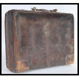 A vintage 20th Century leather attache / briefcase, Carry handle atop with brass locks to the front,