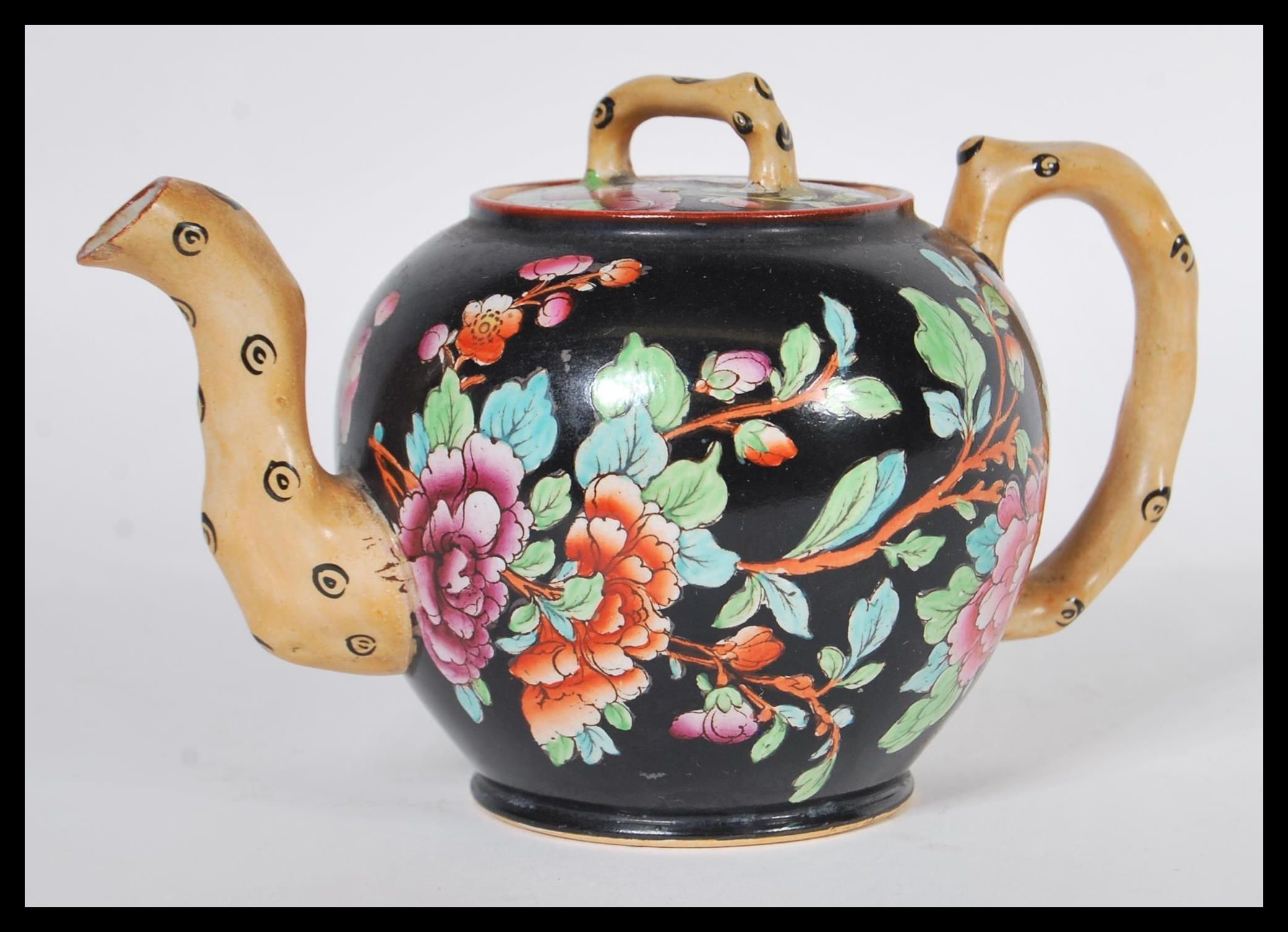 A 19th Century Victorian Wedgwood Etruria black basalt teapot having hand painted chinoiserie floral