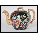 A 19th Century Victorian Wedgwood Etruria black basalt teapot having hand painted chinoiserie floral