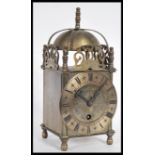 A 19th Century Victorian lantern clock having a pierced frieze with bell to top. The silvered dial