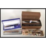 A collection of ballpoint writing pens to include a boxed Cross pen, a Waterman pen having a blue
