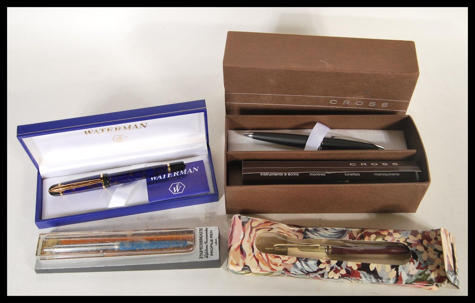 A collection of ballpoint writing pens to include a boxed Cross pen, a Waterman pen having a blue