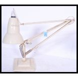 A vintage retro 20th Century Industrial Herbert Terry Anglepoise desk lamp raised on stepped