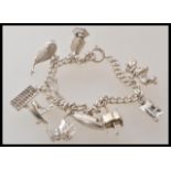 A 20th Century silver charm bracelet having ten charms including a whale, nodding dog, a boat,