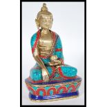 A Contemporary figurine of Buddha in the lotus position raised on pedestal base with died marble