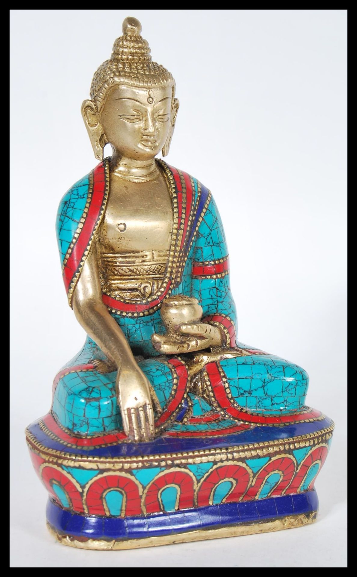 A Contemporary figurine of Buddha in the lotus position raised on pedestal base with died marble