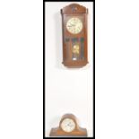 An early 20th Century Edwardian oak cased wall clock, silvered dial together with an inlaid mahogany