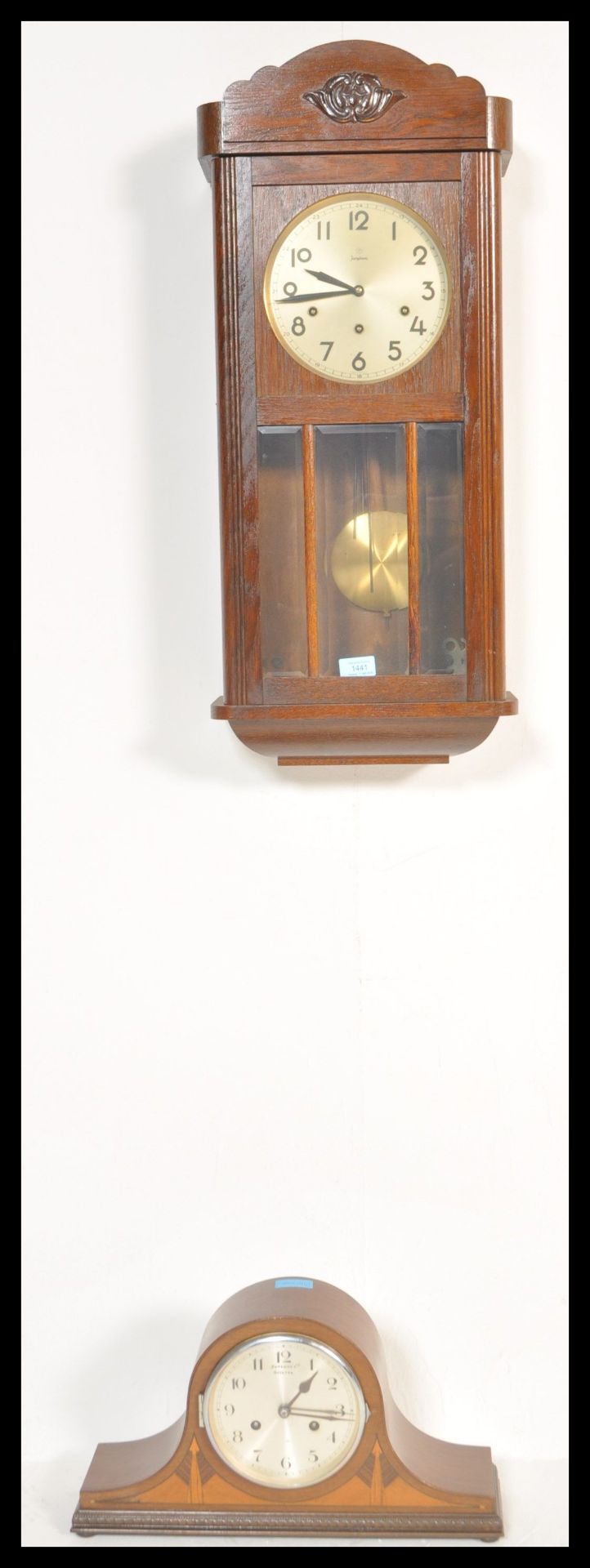 An early 20th Century Edwardian oak cased wall clock, silvered dial together with an inlaid mahogany
