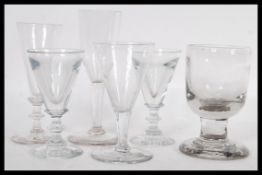 A group of six 18th / 19th Century Georgian glasses to include a pair raised on circular foot with