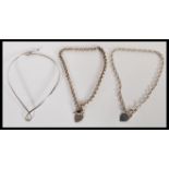 Three large sterling silver necklaces consisting of a rigid silver necklace with crossover end,