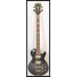 A vintage 1970's Jedson made electric four string bass guitar musical instrument. Black painted