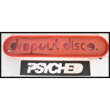 A contemporary retro large light box sign reading Drop Out Disco. The sign of oval form having large