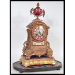 A 19th Century style French Continental clock. The ormolu clock having red ceramic ground features