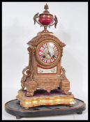 A 19th Century style French Continental clock. The ormolu clock having red ceramic ground features