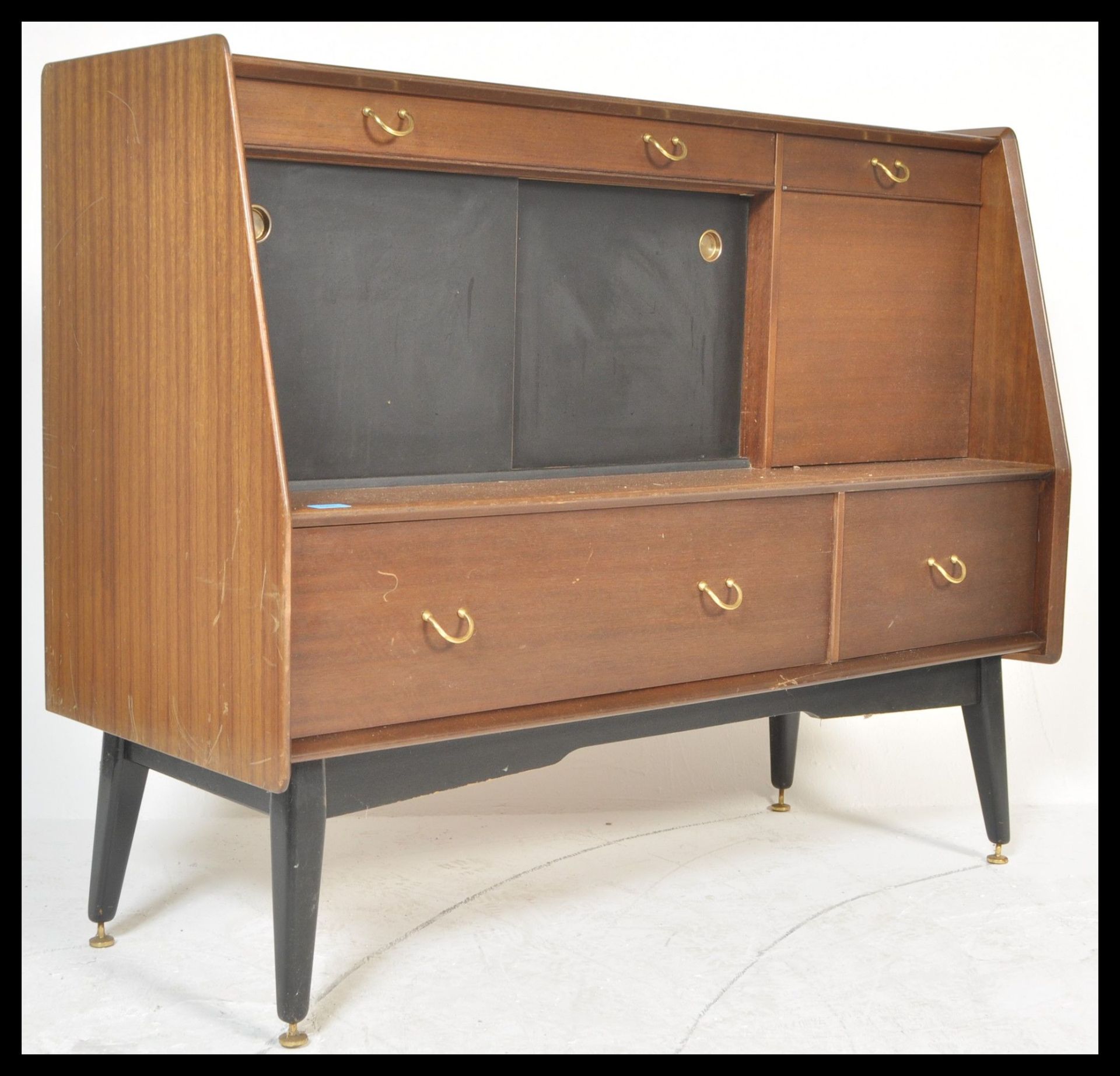 A 1970's G-Plan Librenza tola wood sideboard / credenza / highboard raised on an ebonised suspension