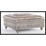 A 19th Century Victorian silver plated jewellery box raised on bun feet with swag adorned window