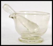 A 19th Century Victorian clear apothecary medical glass pestle and mortar having a pouring lip to