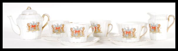 An early 20th Century Bristol crested tea set consisting of teapot, creamer milk jug, sugar bowl,