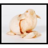 A 19th Century Japanese hand carved ivory netsuke figurine of a chick hatching from an egg. Signed