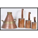 A collection of graduating copper hanging milk measures marked for Southern Dairy along with another