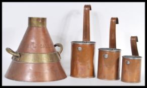A collection of graduating copper hanging milk measures marked for Southern Dairy along with another