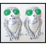 A pair of stamped 800 silver salt and pepper condiments in the form of frogs being set with large