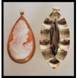 A 9ct gold / 375 hallmarked teardrop shaped cameo pendant being gadrooned to the edges with bale